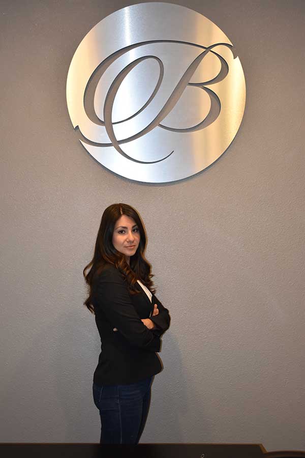 Celedonia Balderrama Celedonia Balderrama standing under Balderrama Law Firm logo